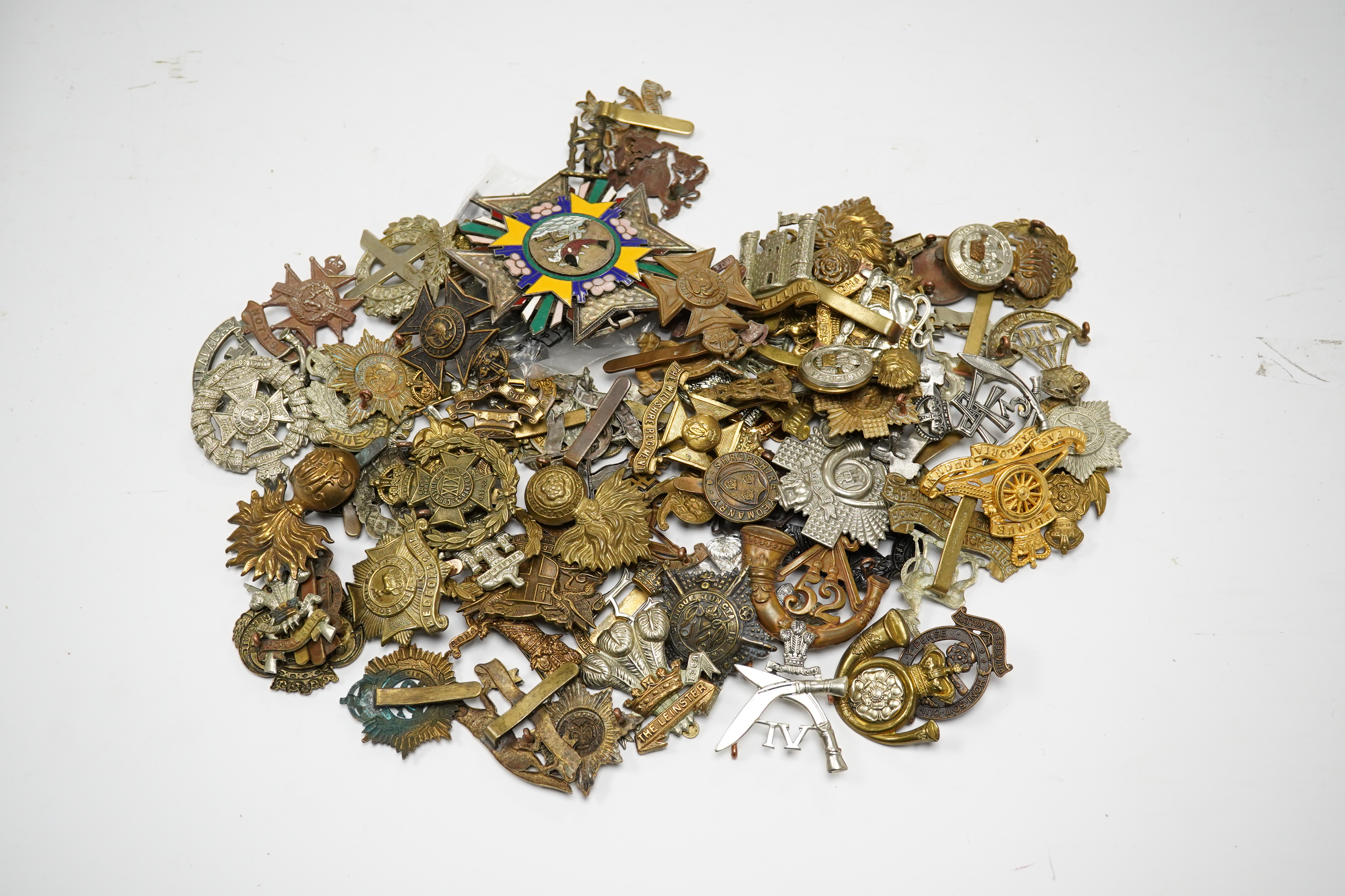 Seventy-eight military cap badges, including; the Royal Horse Artillery, the King’s Own, the Notts and Derby Regiment, the Royal Hussars, the Shropshire Yeomanry, the Herefordshire Regiment, the City of London Volunteer